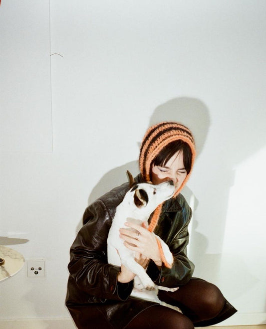 Black Orange striped bonnet with pompons.