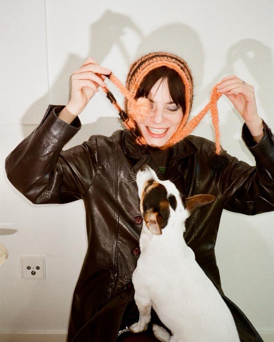 Black Orange striped bonnet with pompons.